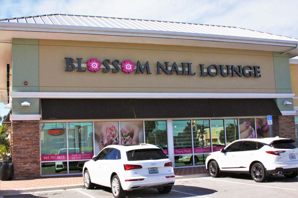 We designed, manufactured and installed front / reverse illuminated channel letter signs for Blossom Nail Lounge Bradenton.