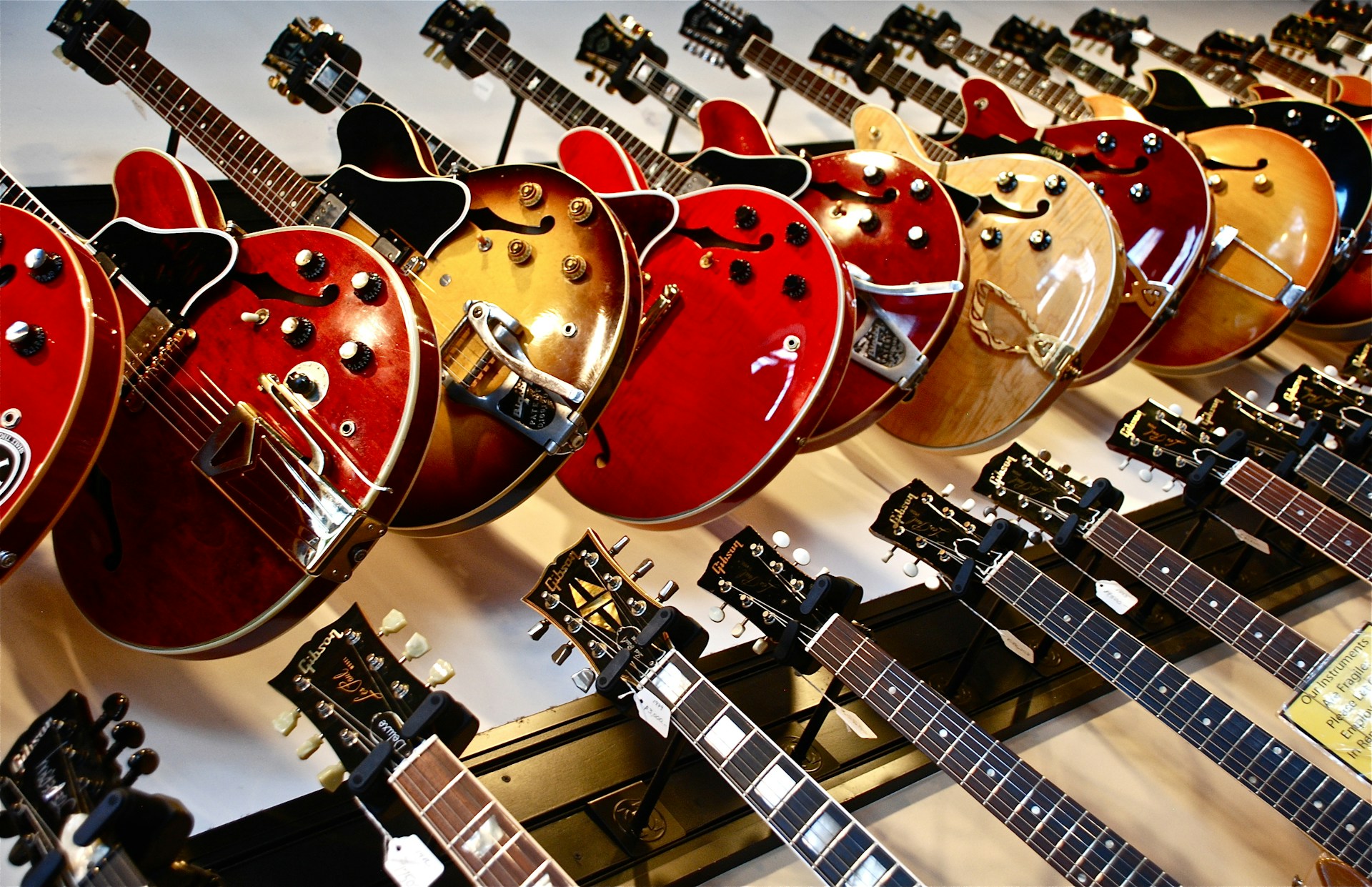 Guitars hanging on the wall - Music Store Signs post